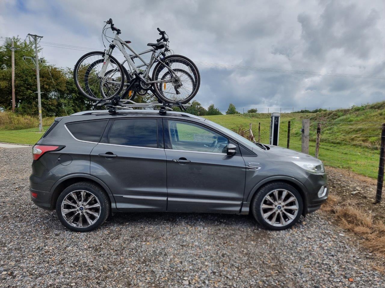 Roof-mounted Thule bike carriers fitted to a car
